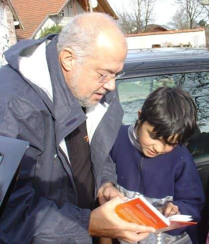 Bob sharing Bayash boy a childrens Bible in his mother tongue